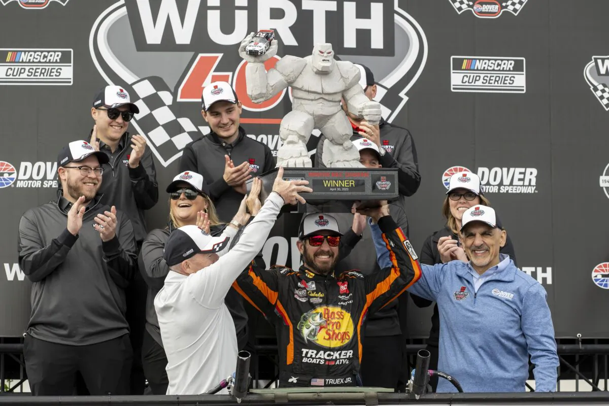 Martin Truex Jr. hoists the trophy after winning the NASCAR 400 auto race at Dover Motor Speedway in Dover, Del., on May 1, 2023. (Jason Minto/AP Photo)