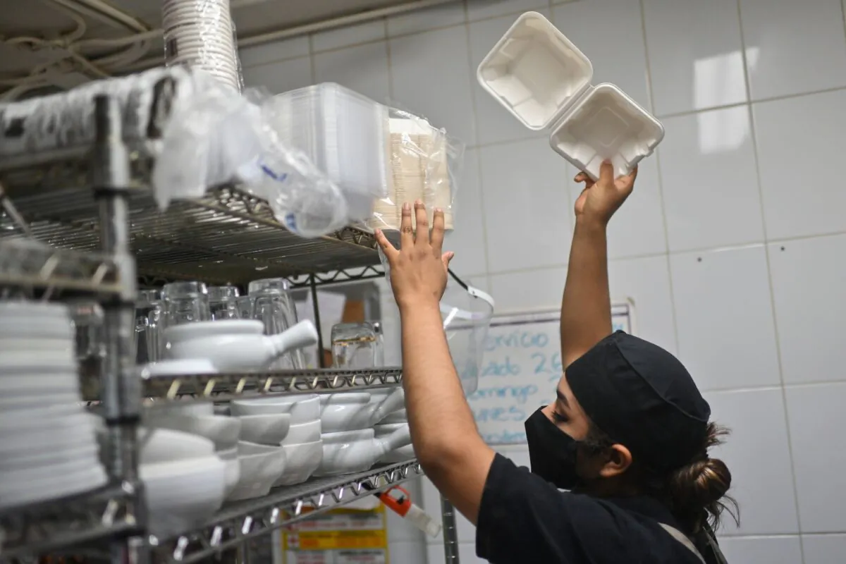 A restaurant worker packs food in a biodegradable and compostable container in a file photo. (Pedro Pardo/AFP via Getty Images)