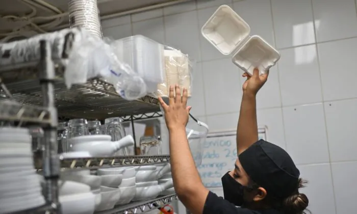 A restaurant worker packs food in a biodegradable and compostable container to fill a food delivery order in Mexico City on Jan. 7, 2021. (Photo by PEDRO PARDO/AFP via Getty Images)