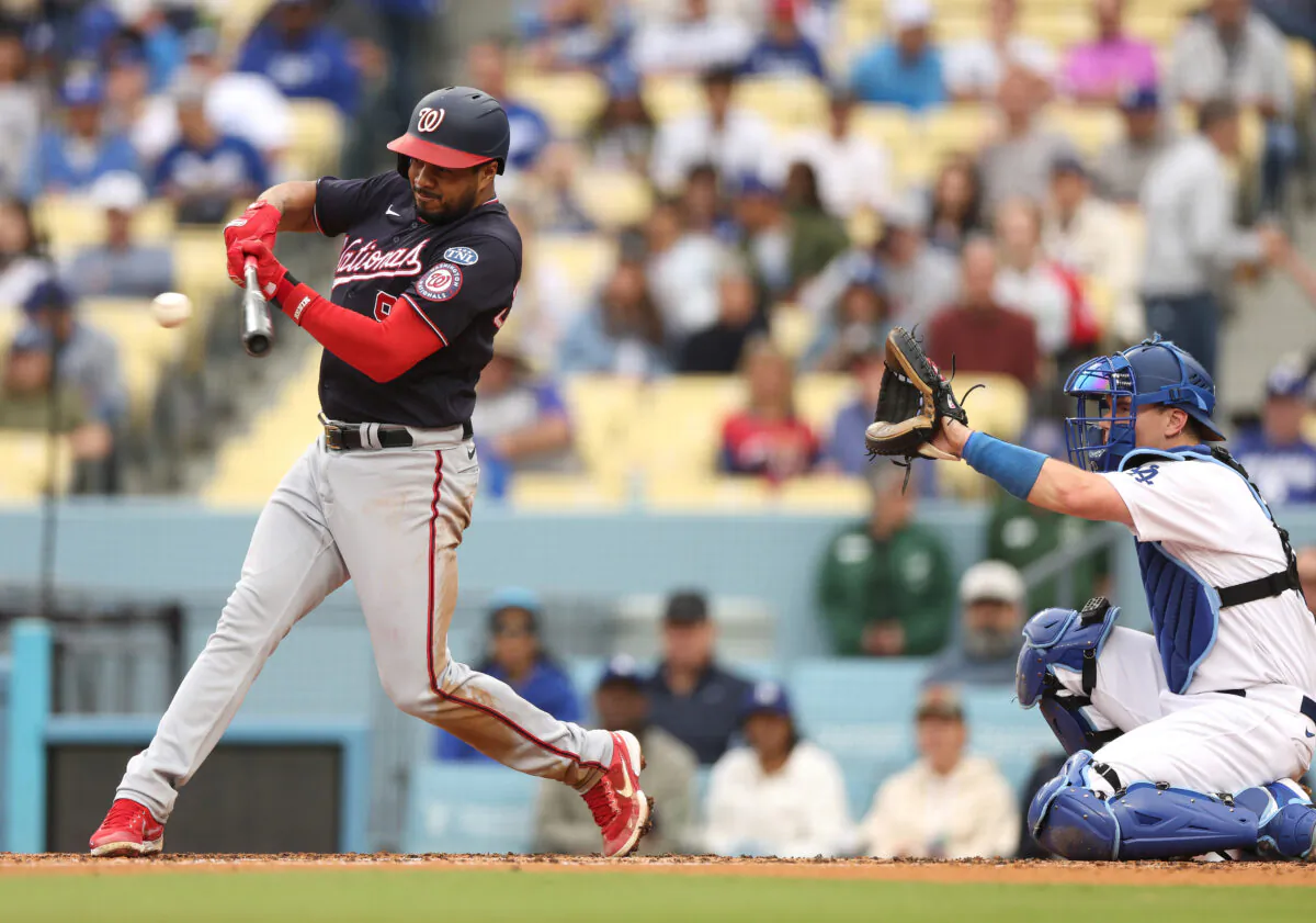 Jeimer Candelario (9) of the Washington Nationals singles in front of Will Smith (16) of the Los Angeles Dodgers to score Joey Meneses (45) and tie the game 3–3, during the third inning at Dodger Stadium in Los Angeles on May 31, 2023. (Harry How/Getty Images)