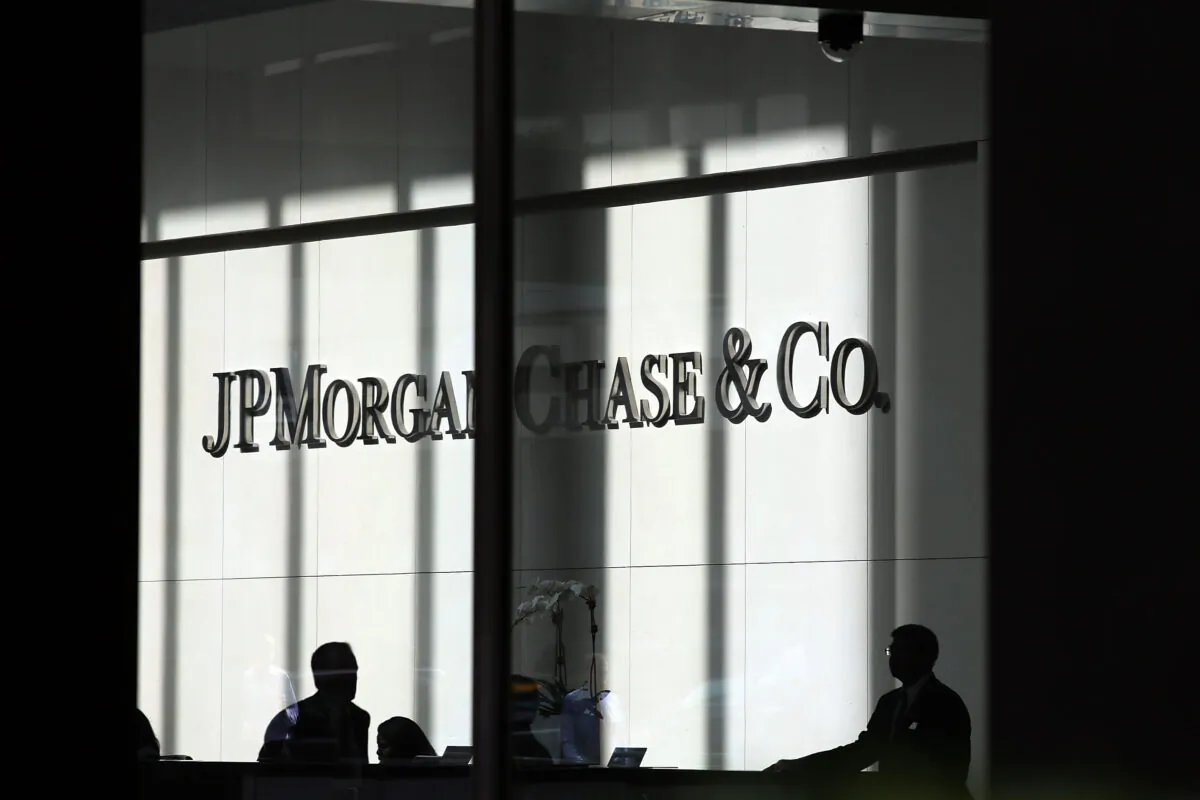 People pass a sign for JPMorgan Chase at it's headquarters in Manhattan in this file photo. (Spencer Platt/Getty Images)