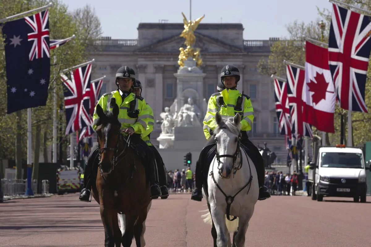 Police officers patrol at Buckingham Palace ahead of the coronation of Britain's King Charles III, in London on April 29, 2023. (Kin Cheung/AP Photo)