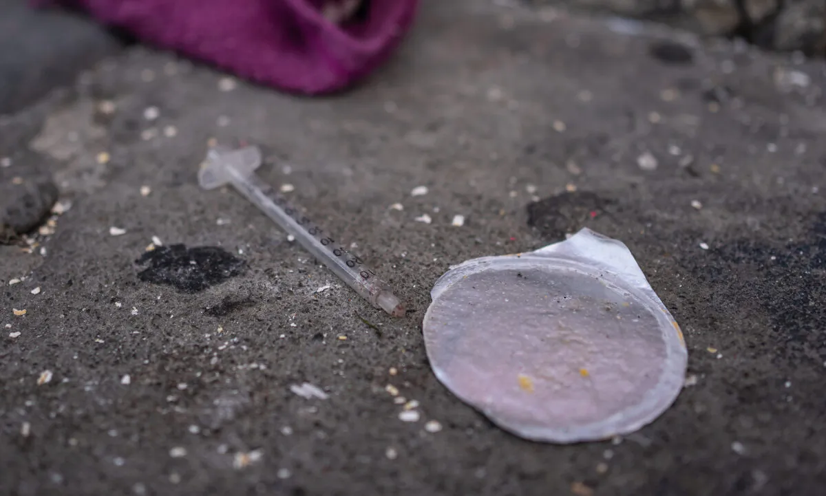 A used syringe sits discarded on the sidewalks of San Francisco, Calif., on Feb. 23, 2023. (John Fredricks/The Epoch Times)