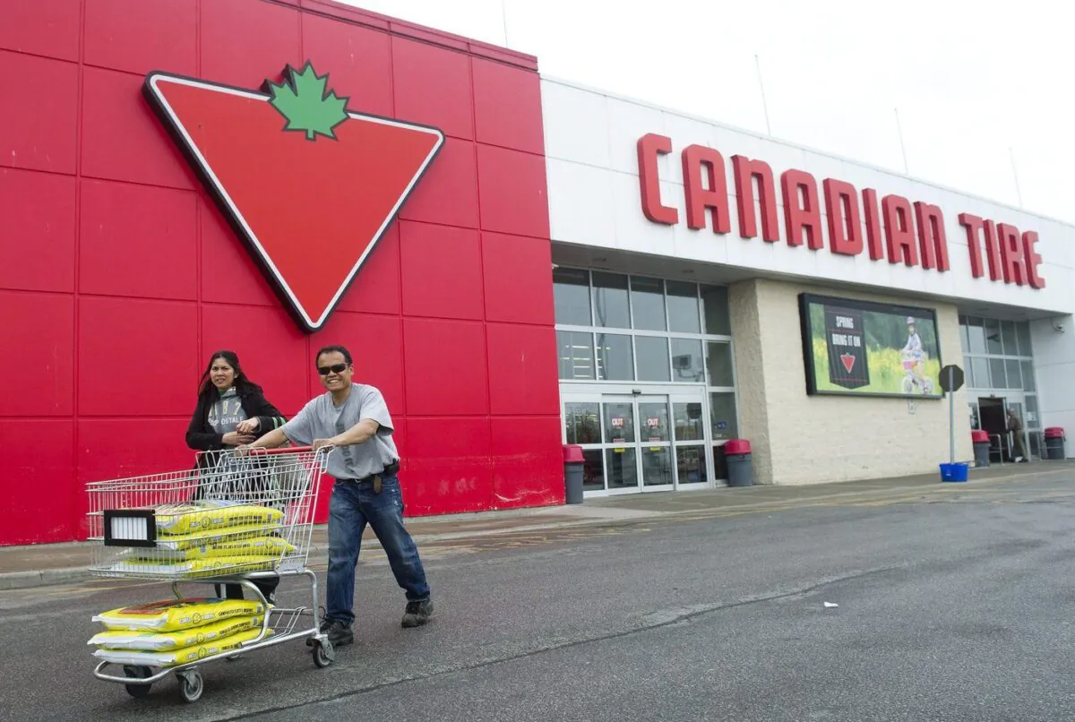 People leave after shopping at Canadian Tire in Toronto on May 12, 2011. (The Canadian Press/Nathan Denette)