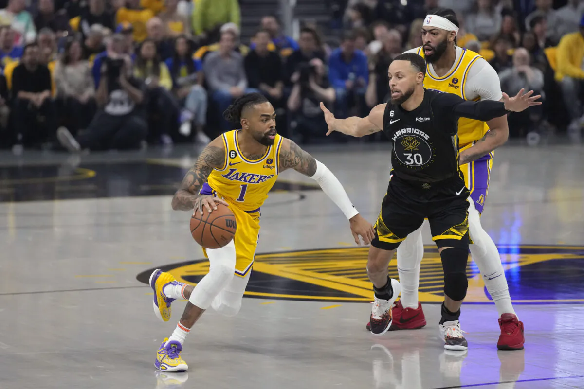 Los Angeles Lakers guard D'Angelo Russell (1) dribbles past Golden State Warriors guard Stephen Curry (30) during the first half of an NBA basketball Western Conference semifinal game in San Francisco on May 2, 2023. (Jeff Chiu/AP Photo)