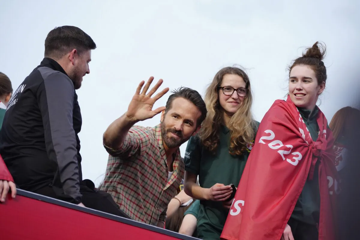 Wrexham co-owner Ryan Reynolds (C) celebrates with members of the Wrexham FC soccer team the promotion to the Football League in Wrexham, Wales, on May 2, 2023. (Jon Super/AP Photo)