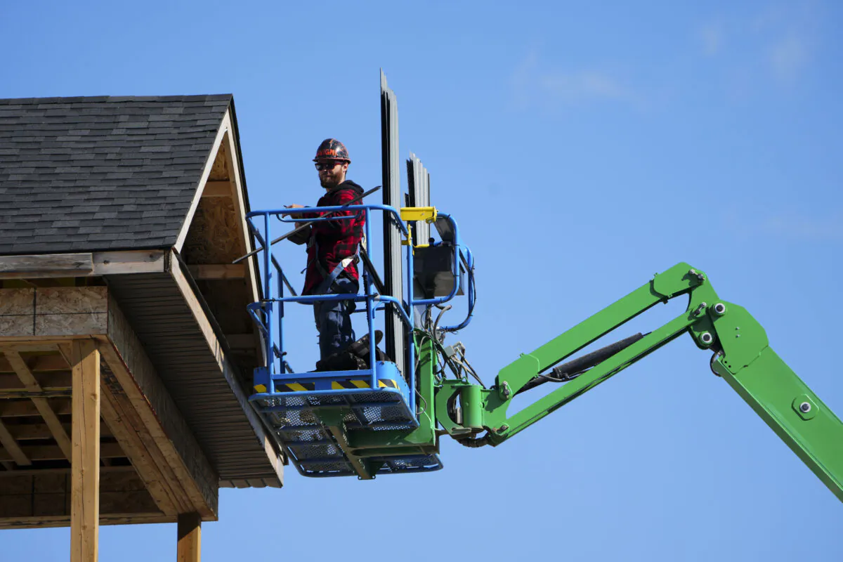 A construction worker works from a lift in a new housing development in Ottawa on Oct. 14, 2022. (Sean Kilpatrick/The Canadian Press)