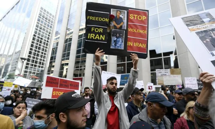 Members of the Iranian community and their supporters rally in solidarity with protesters in Iran, after 22-year-old Mahsa Amini died in police custody for allegedly improperly wearing a hijab, in Ottawa on Sept. 25, 2022. (The Canadian Press/Justin Tang)

