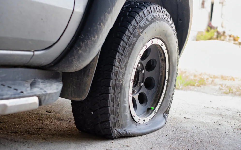 An undated image of a car with a flat tyre. (Phoderstock/Shutterstock)