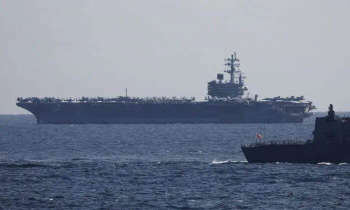 The USS Ronald Reagan, a Nimitz-class nuclear-powered super carrier, participates in an International Fleet Review commemorating the 70th anniversary of the founding of the Japan Maritime Self-Defense Force at Sagami Bay off Yokosuka, Japan, on Nov. 6, 2022. (Issei Kato-Pool/Getty Images)