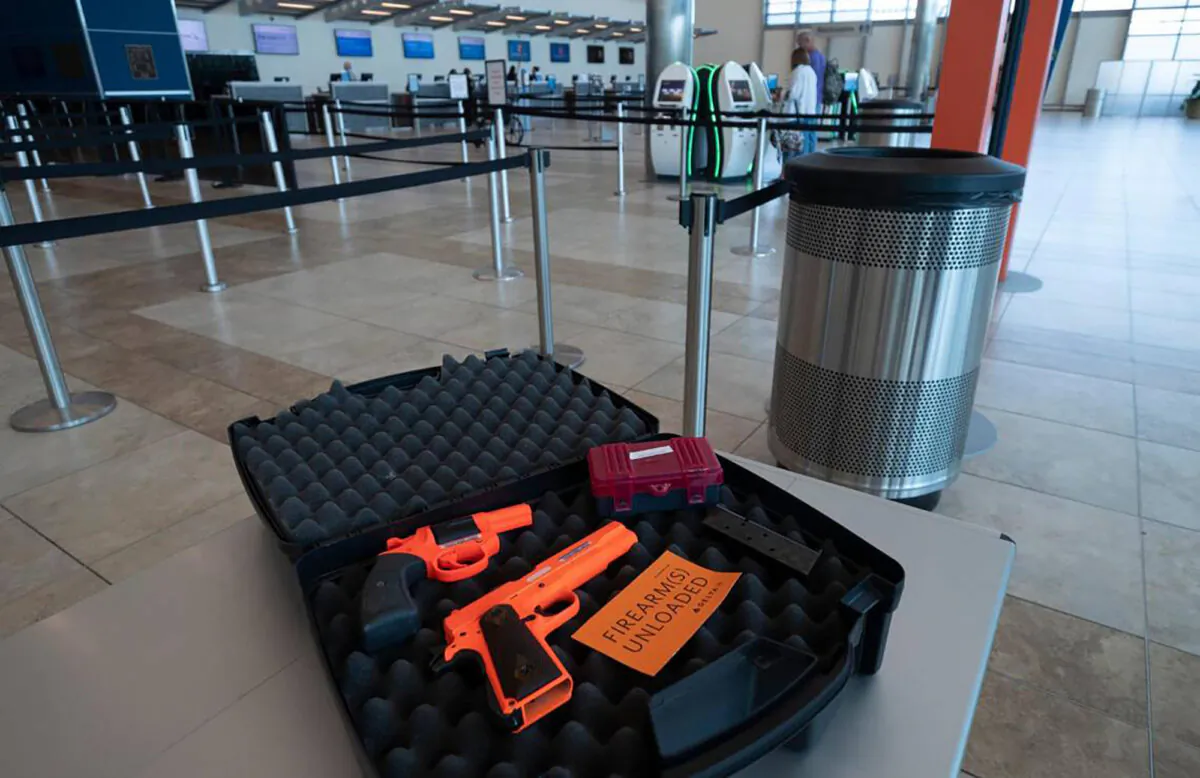 Decommissioned guns are used for display purposes as a TSA representative explains the proper way to pack and declare guns for air travel at Myrtle Beach International Airport on Sept. 13, 2022, in Myrtle Beach, South Carolina. (Jason Lee/The State/TNS)