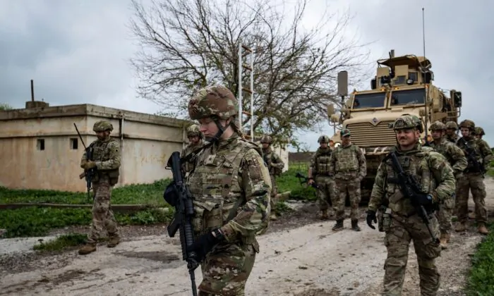 U.S. soldiers patrol the countryside of Rumaylan (Rmeilan) in Syria's northeastern Hasakeh province near the border with Turkey on April 13, 2023. (Delil Souleiman/AFP via Getty Images)