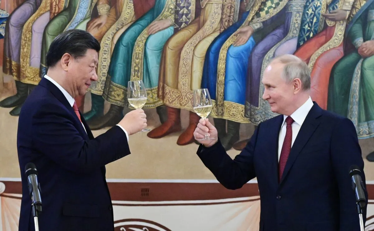 Russian President Vladimir Putin and China’s President Xi Jinping make a toast during a reception following their talks at the Kremlin in Moscow on March 21, 2023. (Pavel Byrkin/Sputnik/AFP via Getty Images)