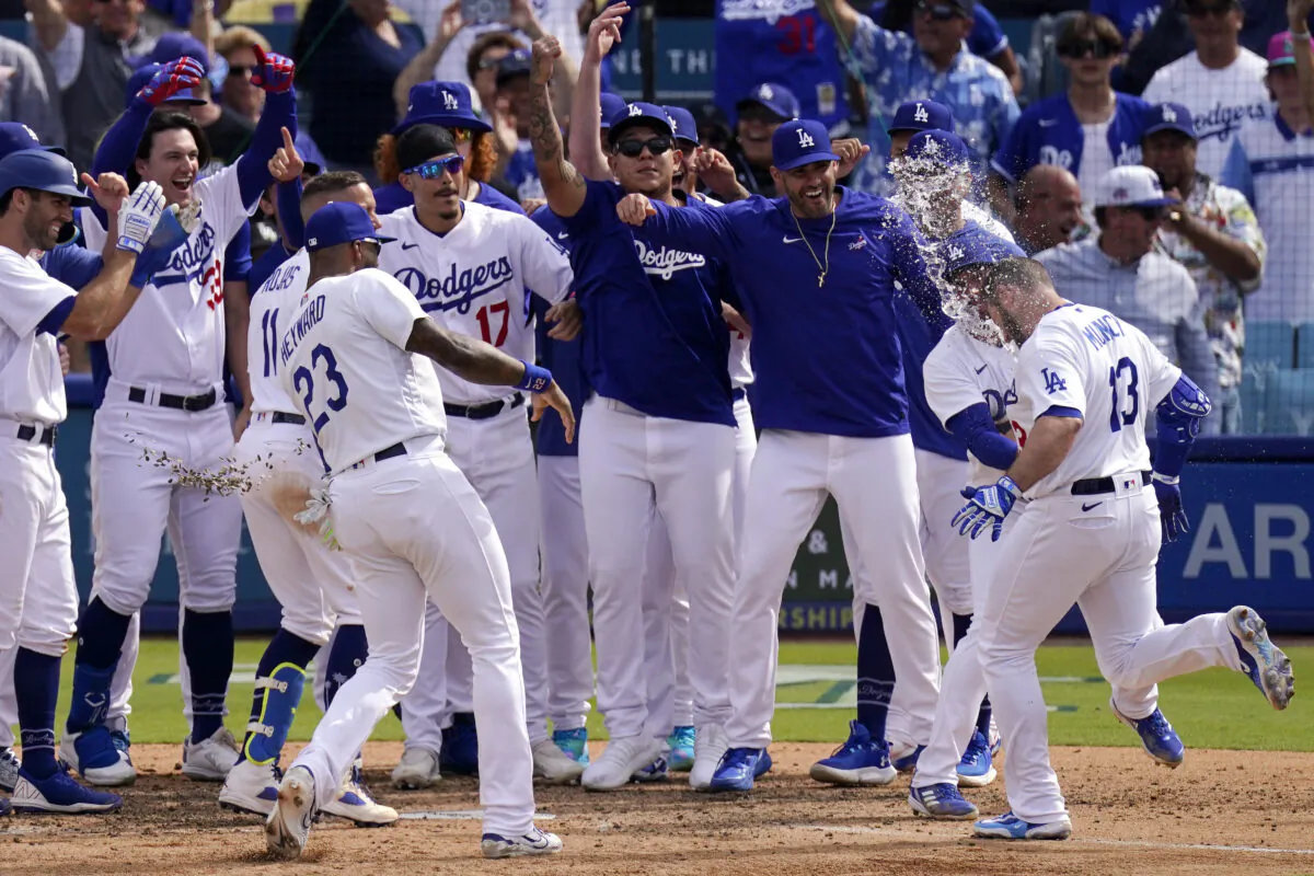 Los Angeles Dodgers' Max Muncy, right, is mobbed by teammates as he scores after hitting a walk-off grand slam during the ninth inning of a baseball game against the Philadelphia Phillies in Los Angeles on May 3, 2023. (Mark J. Terrill/AP Photo)
