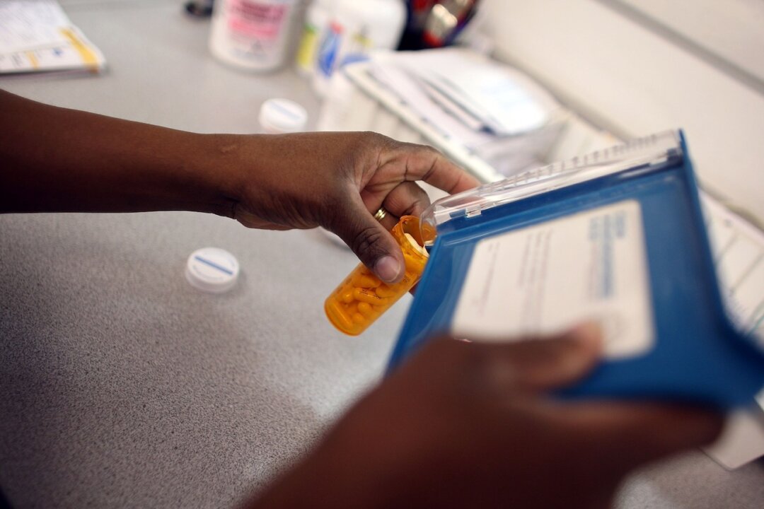 A pharmacy technician counts out a prescription of antibiotic pills in Miami, Florida, on Aug. 7, 2007. (Joe Raedle/Getty Images)