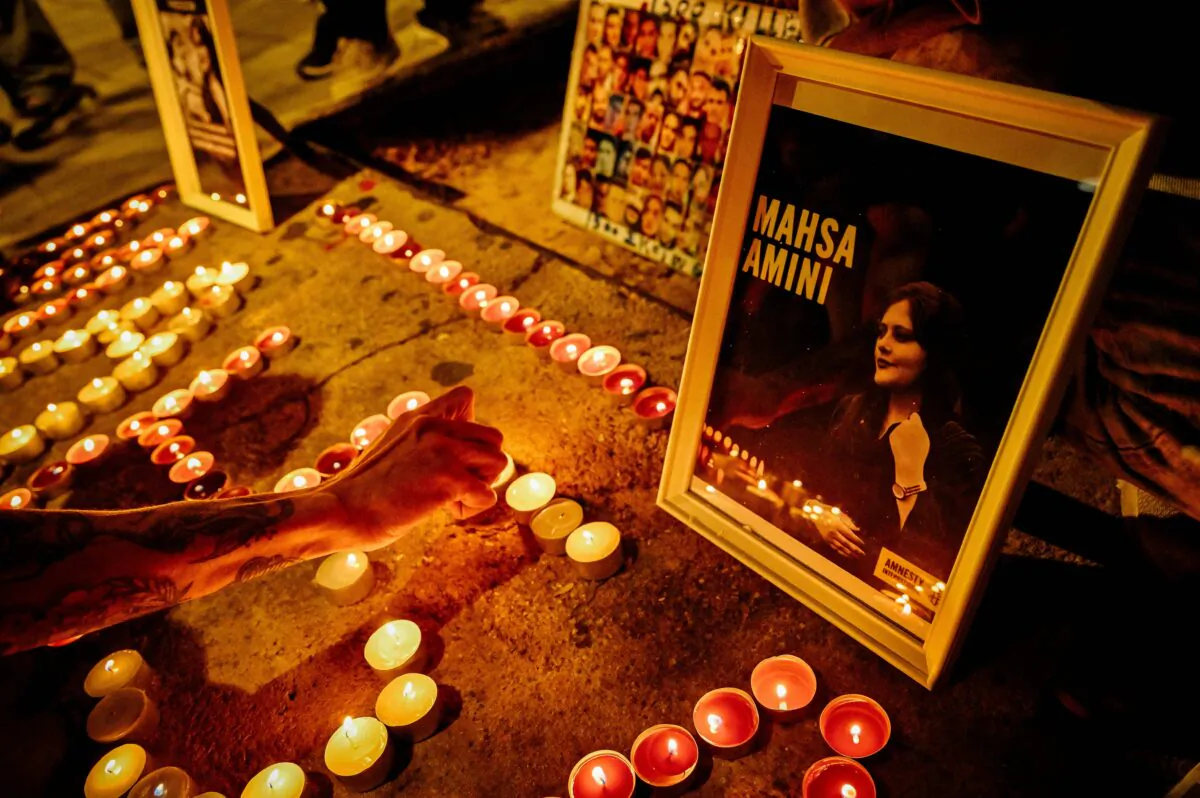 Iranian refugees and Iranians living in Greece lit candles forming the name 'Mahsa' during a demonstration to commemorate 40 days from the death of Iranian Mahsa Amini while in police custody in Iran, in central Athens, on Oct. 29, 2022. The death of Mahsa Amini, 22, detained allegedly for not wearing her hijab properly trigerred massive protests in Iran and worldwide. (Louisa Gouliamaki/AFP via Getty Images)