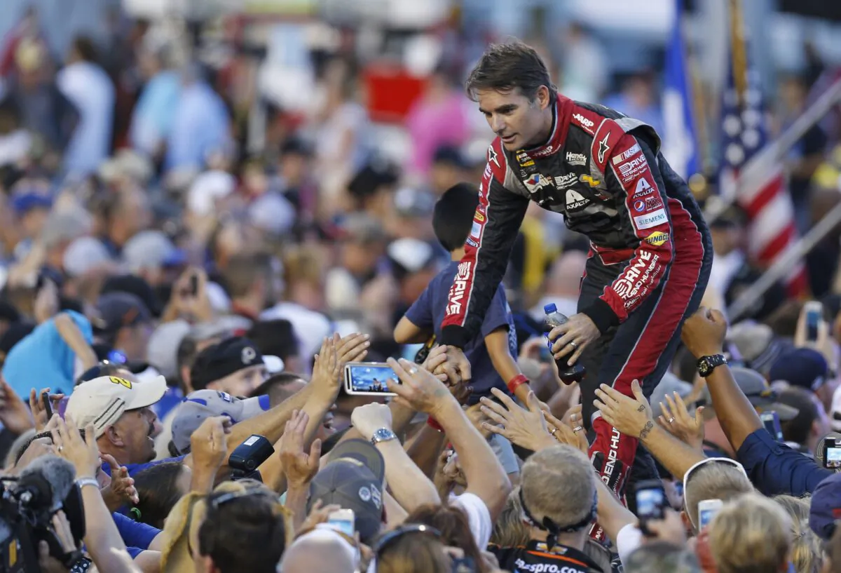 Jeff Gordon greets fans during driver introductions prior to the start of the NASCAR Sprint Cup race at Richmond International Raceway in Richmond, Va., on Sept. 6, 2014. (Steve Helber/AP Photo)