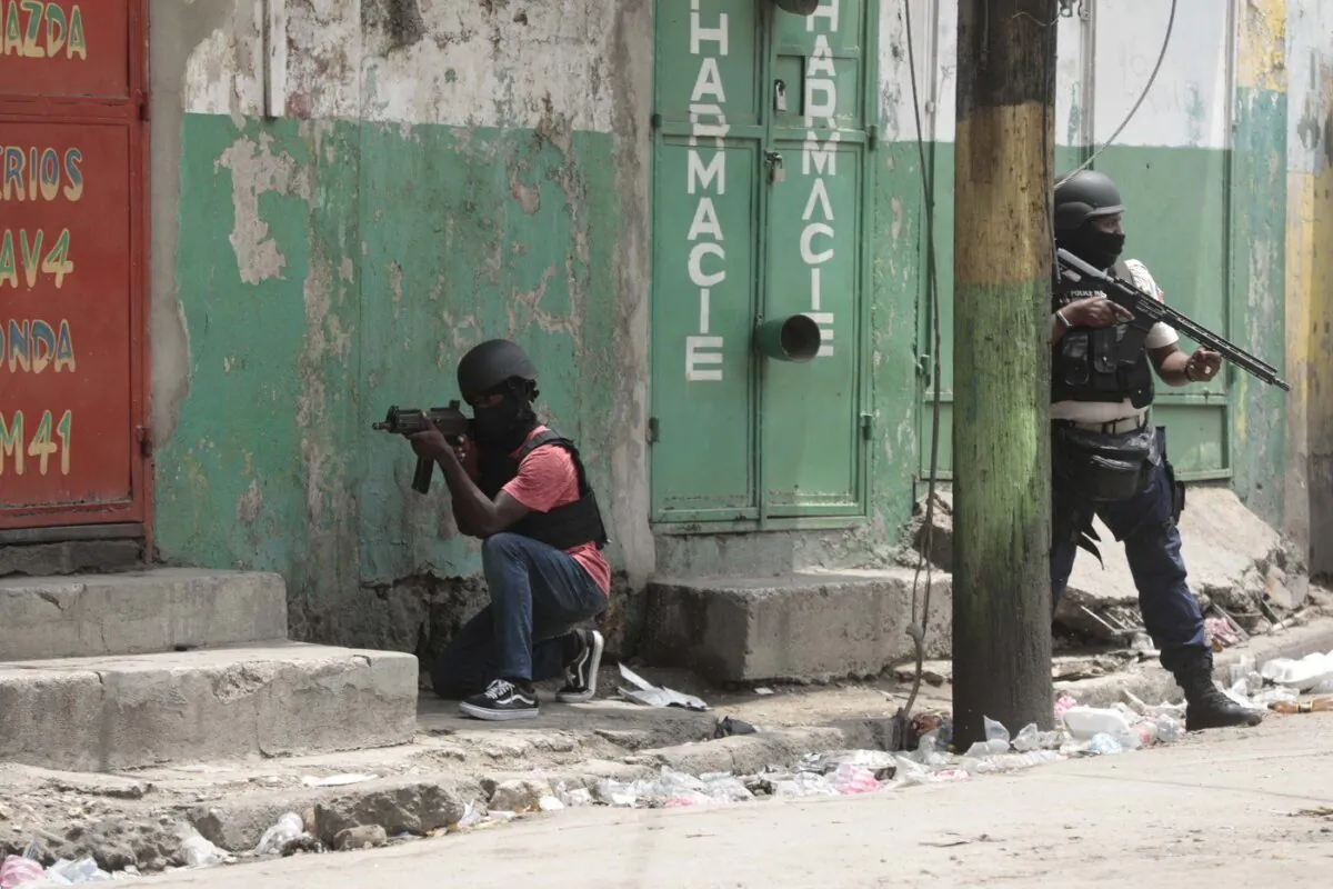 The House foreign-affairs committee is urging Ottawa to not send troops to Haiti, but instead beef up sanctions that target that country's political and economic elite. Police officers take cover during an anti-gang operation in the Portail neighborhood of Port-au-Prince, Haiti, Tuesday, April 25, 2023. (The Canadian Press/AP-Odelyn Joseph)
