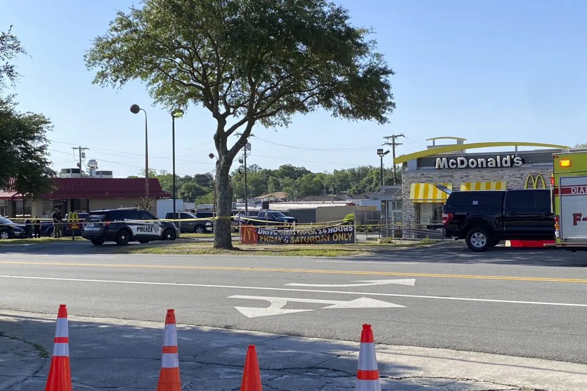 Police vehicles sit parked in front of a McDonald's restaurant as police investigate a shooting in which multiple people were killed in Moultrie, Ga., on May 4, 2023. (Kamira Smith/The Moultrie Observer via AP)