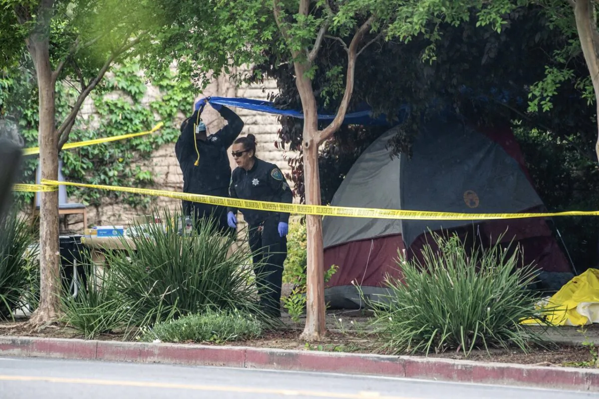 Police investigate the site where a homeless woman was stabbed several times through the side of her tent near Second and L streets in Davis, Calif., on May 2, 2023. (Hector Amezcua/The Sacramento Bee via AP)