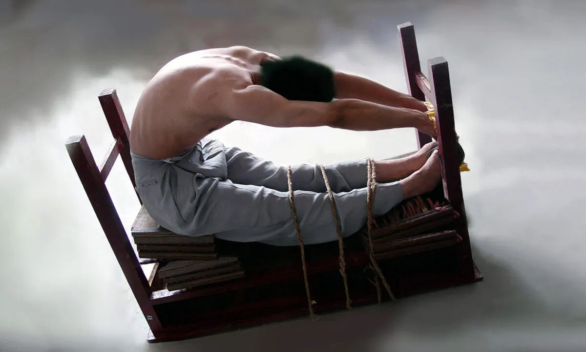 A reenactment of the “tiger bench” torture method: A Falun Gong adherent is tied to an upside-down table in a position that can inflict unbearable pain and  make the victim lose consciousness. (Minghui.org)
