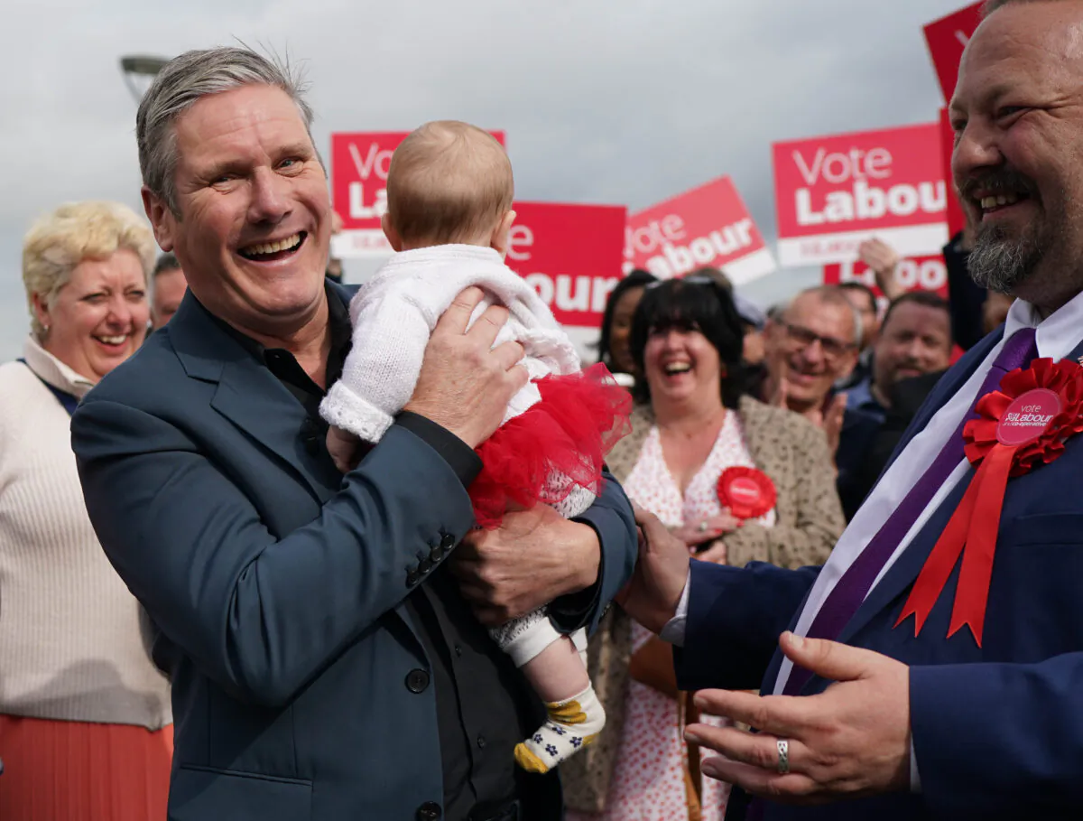 Labour leader Keir Starmer holds five month old Hazel (no surname given) as he joins party members in Chatham, Kent, where Labour has taken overall control of Medway Council for the first time since 1998 on May 5, 2023. (Gareth Fuller/PA Wire) 