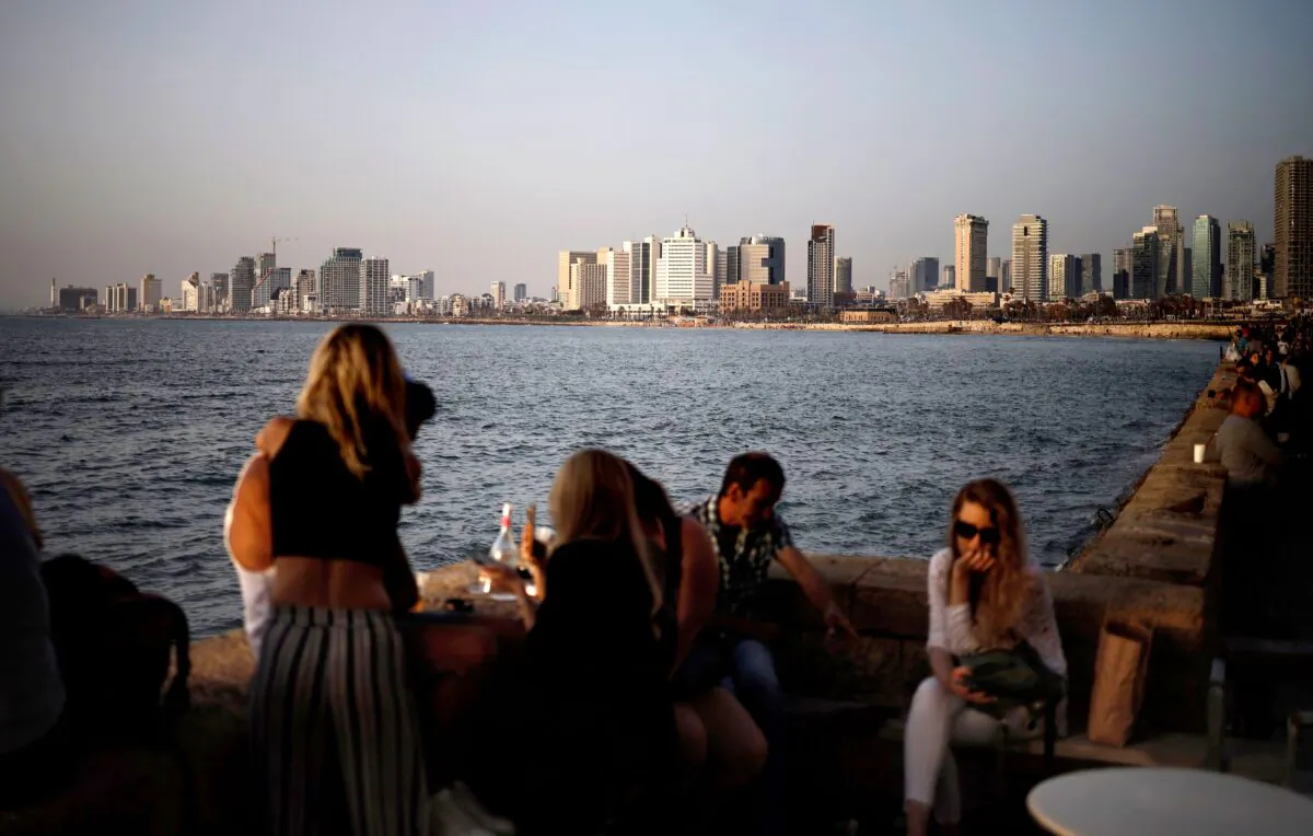 People gather at an open-air restaurant in Jaffa across from the Israeli port city of Tel Aviv, on April 13, 2019. (Thomas Coex/AFP via Getty Images)