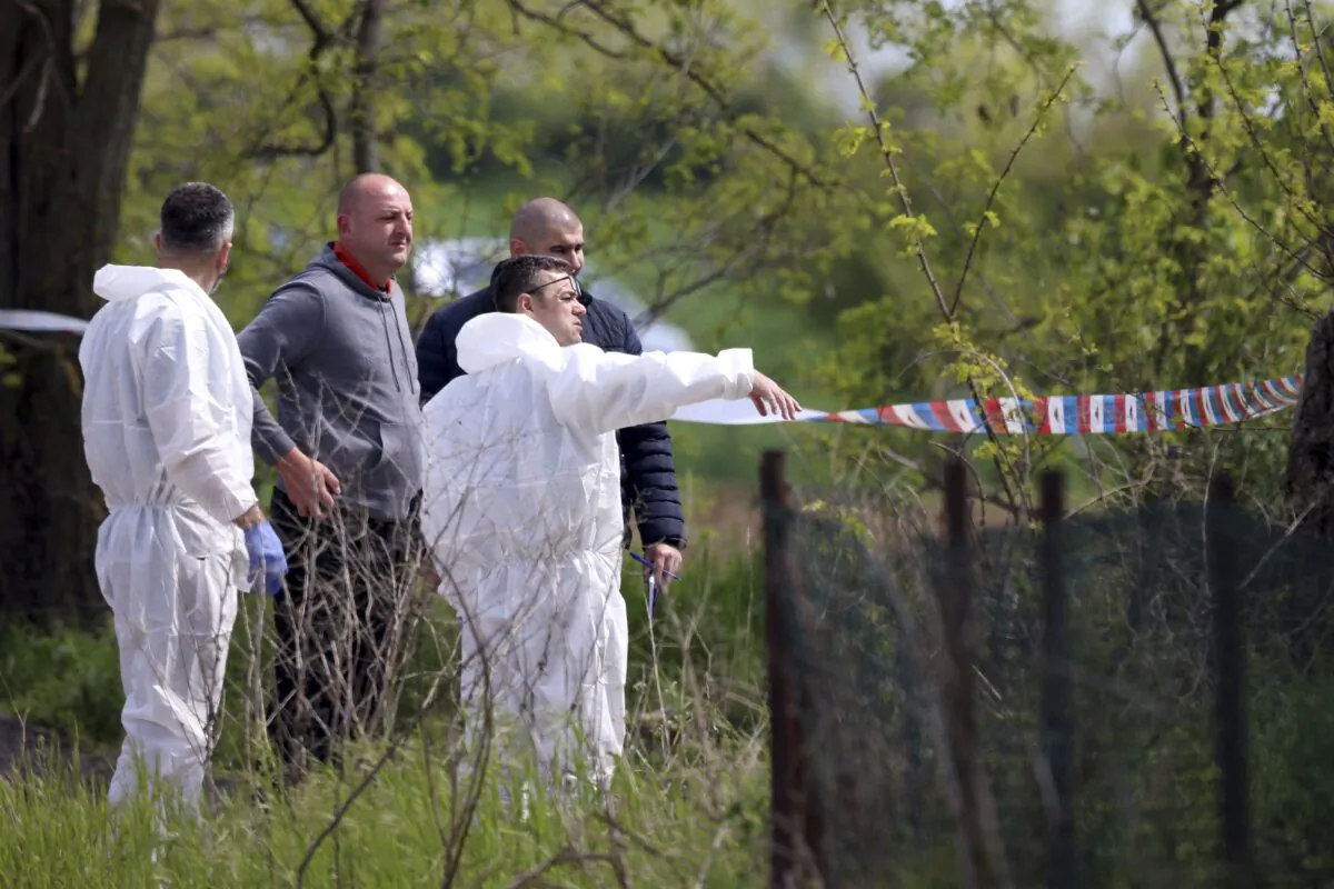 Forensic police inspects the scene around a car in the village of Dubona, some 50 kilometers (30 miles) south of Belgrade, Serbia, on May 5, 2023. (Armin Durgut/AP Photo)