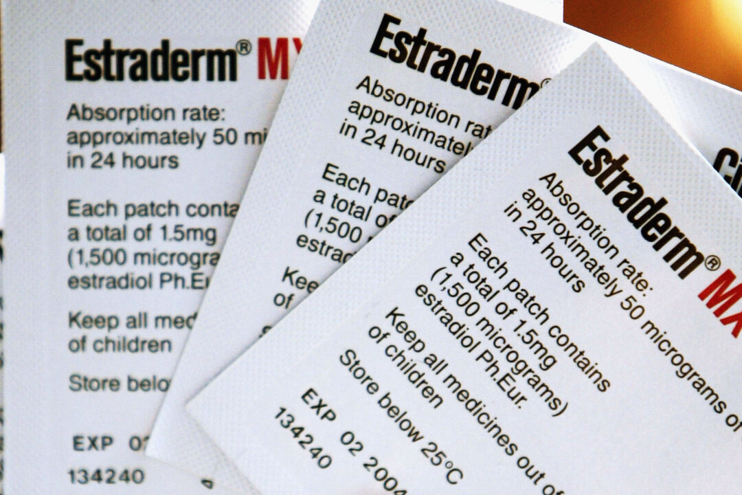 A woman holds her Hormone Replacement Therapy patches in London on Aug. 8, 2003. (Ian Waldie/Getty Images)