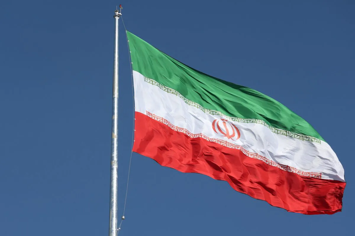 The Iranian flag is seen flying over a street in Tehran, Iran, on Feb. 3, 2023. (Majid Asgaripour/West Asia News Agency via Reuters)