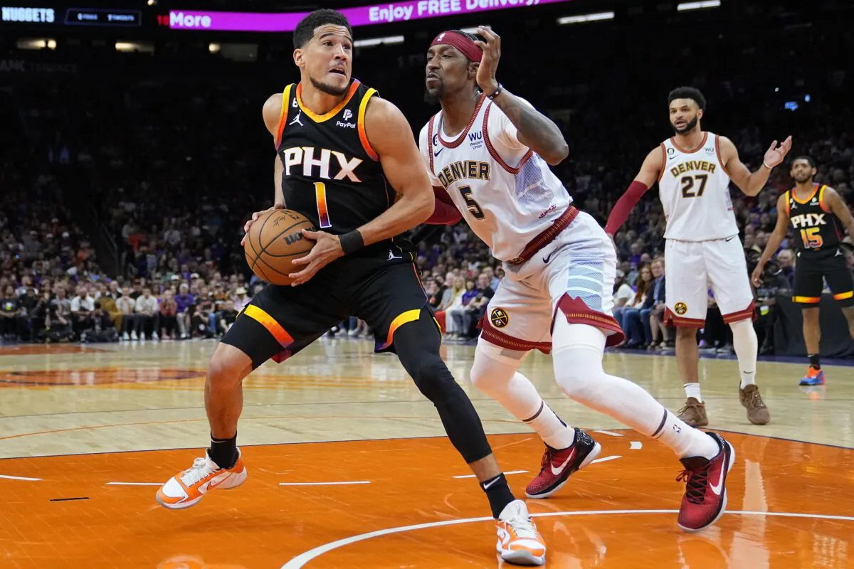 Phoenix Suns guard Devin Booker (1) looks to shoot as Denver Nuggets guard Kentavious Caldwell-Pope (5) defends during the first half of Game 3 of an NBA basketball Western Conference semifinal game in Phoenix on May 5, 2023. (Matt York/AP Photo)