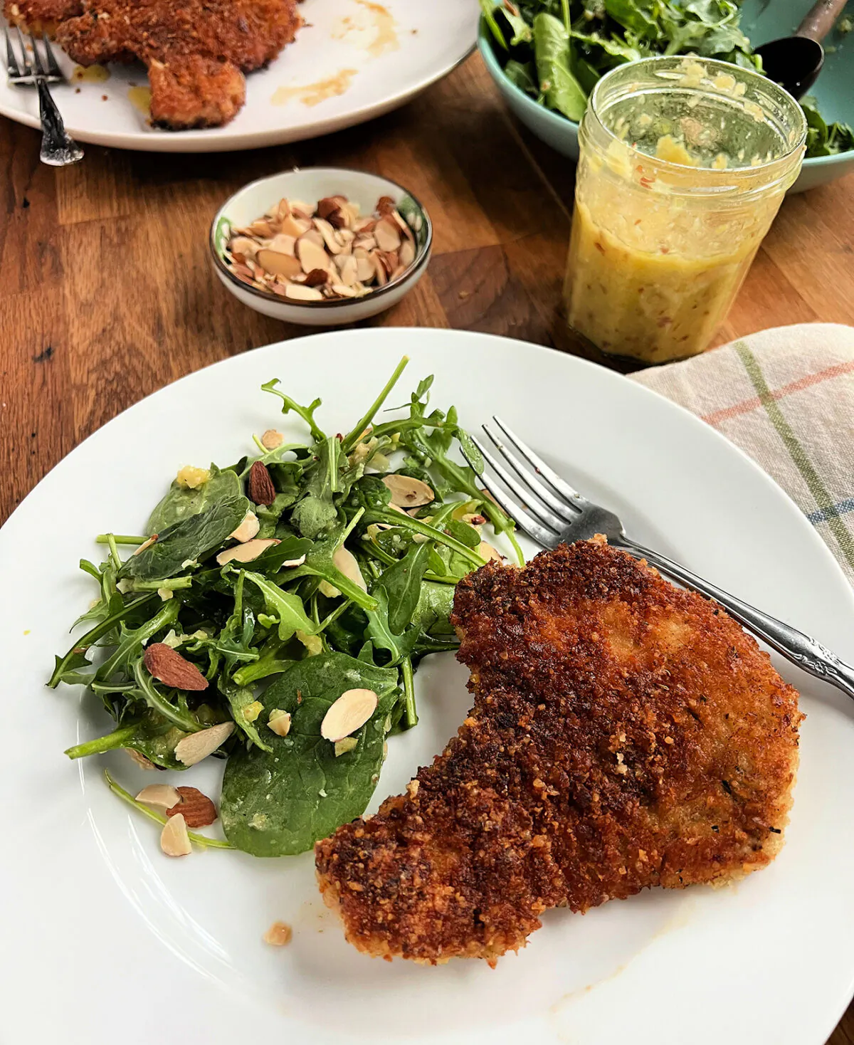 Fried panko-breaded pork chops are paired with an arugula salad dressed in a bright and zesty whole-lemon vinaigrette. (Gretchen McKay/Pittsburgh Post-Gazette/TNS)