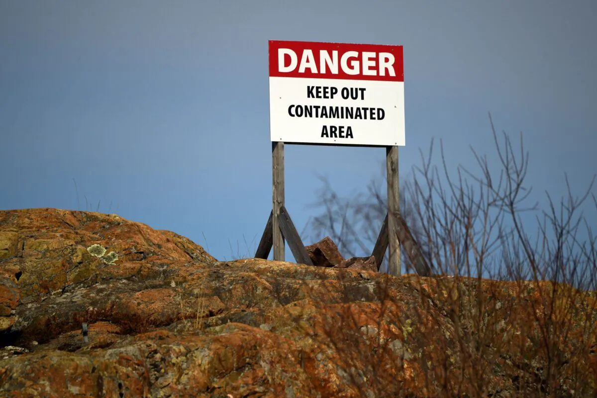 A sign warns of the danger of a contaminated area in a file photo. (Patrick T. Fallon/AFP via Getty Images)
