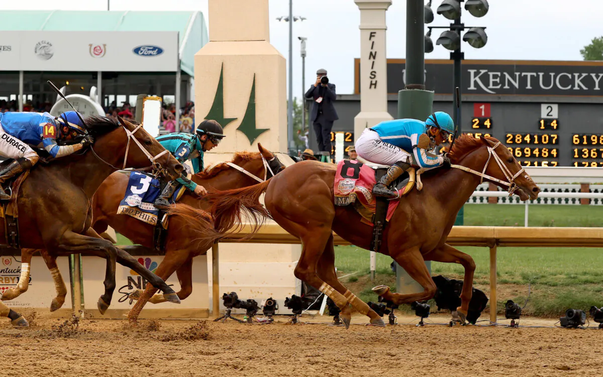 Mage (8) ridden by jockey Javier Castellano crosses the finish line to win the 149th running of the Kentucky Derby at Churchill Downs in Louisville, Ky., on May 6, 2023. (Sam Mallon/Getty Images)