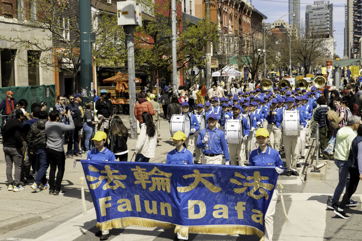 Falun Dafa adherents participate in a parade in downtown Toronto on May 6, 2023, marking the 31st anniversary of the public introduction of the spiritual practice in China on May 13, 1992. (Evan Ning/The Epoch Times)