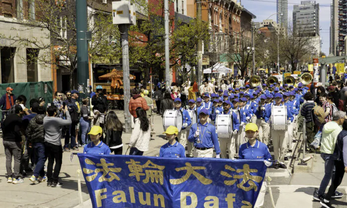 Falun Dafa adherents participate in a parade in downtown Toronto on May 6, 2023, marking the 31st anniversary of the public introduction of the spiritual practice in China on May 13, 1992. (Evan Ning/The Epoch Times)