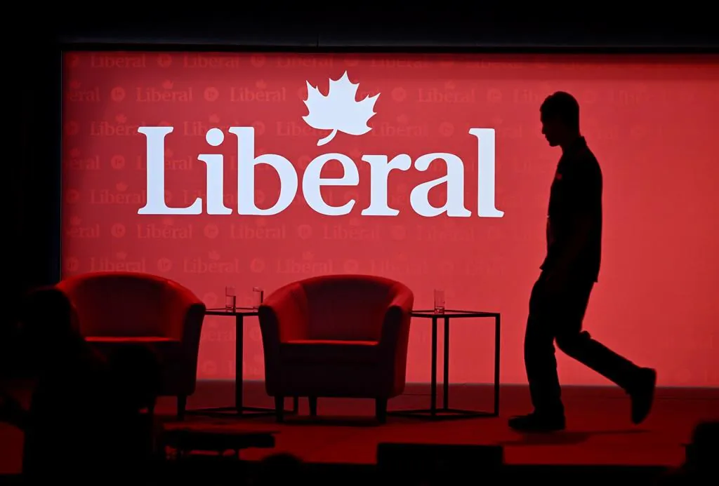 A stagehand works on the stage in between presenters at the 2023 Liberal National Convention in Ottawa on May 4, 2023. (The Canadian Press/Justin Tang)