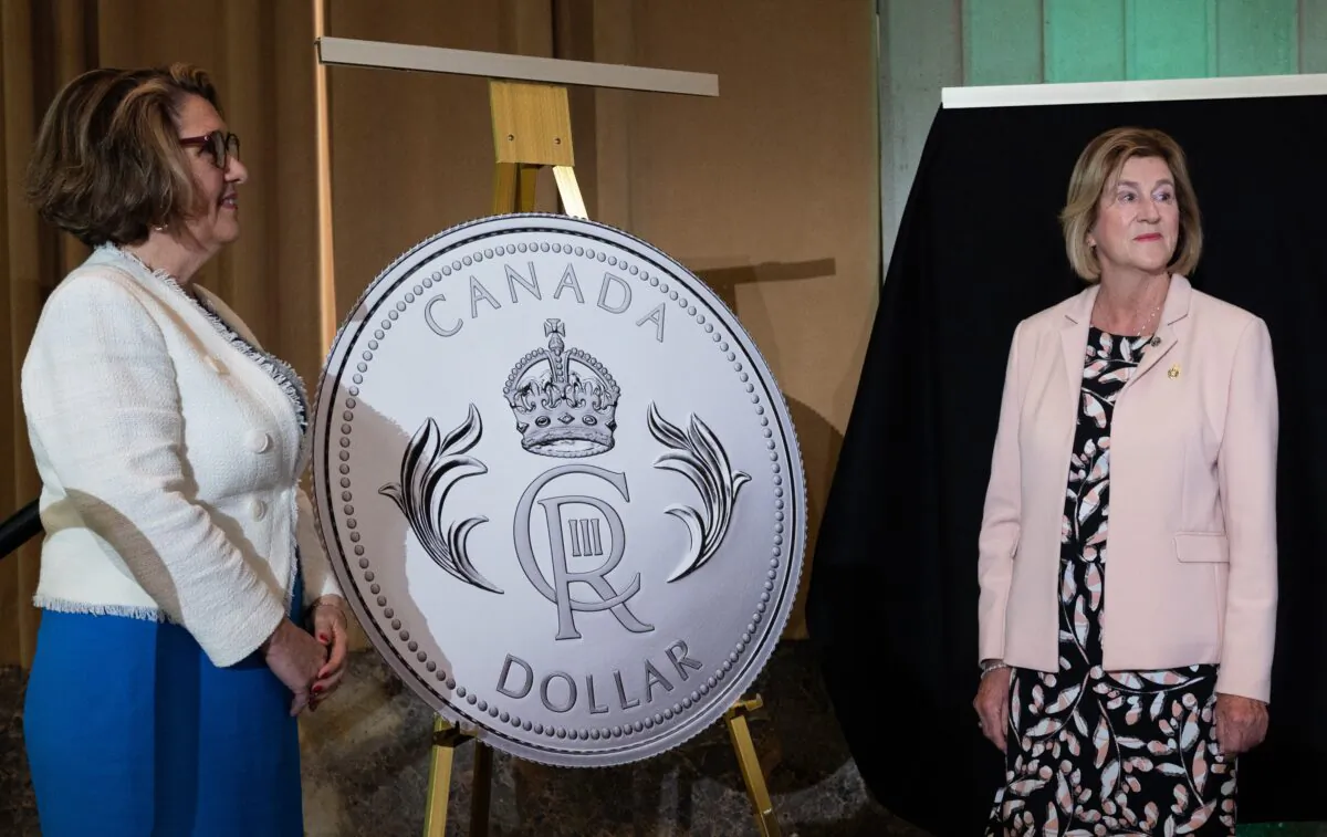 The Royal coin is unveiled by Minister of Public Services and Procurement Helena Jaczek (R) and President and CEO of the Royal Canadian Mint Marie Lemay during coronation celebrations in honour of King Charles III, in Ottawa on May 6, 2023. (The Canadian Press/Spencer Colby)