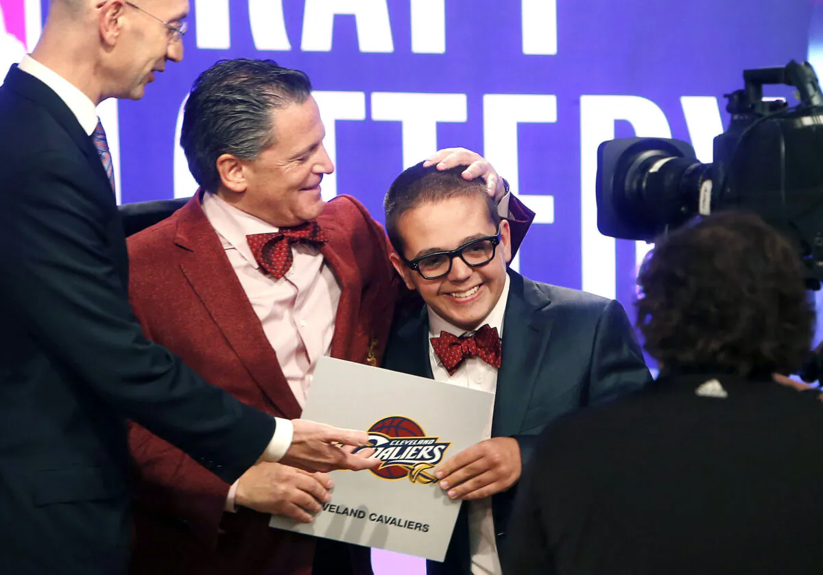 Cleveland Cavaliers owner Dan Gilbert congratulates his son Nick Gilbert after the team won the NBA basketball draft lottery in New York on May 21, 2013. (Jason DeCrow/AP Photo)