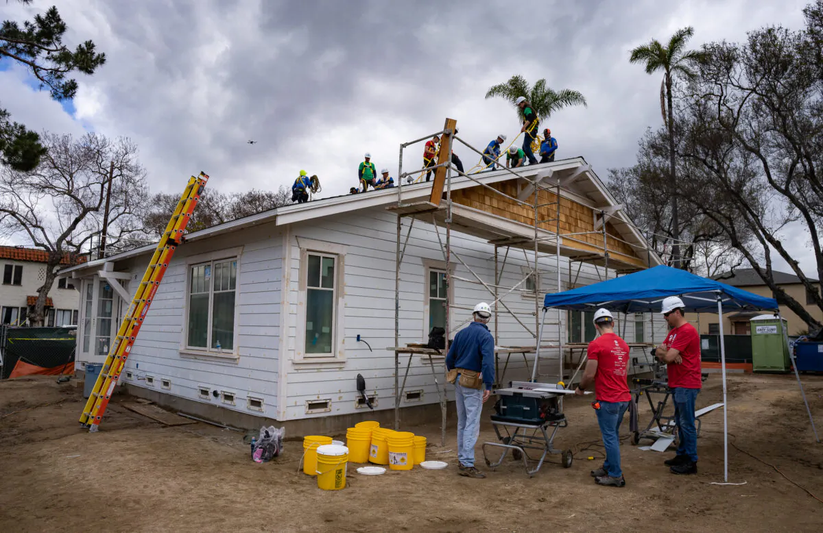 Habitat for Humanity members work on finishing two housing units for lower income families in Santa Ana, Calif., on May 5, 2023. (John Fredricks/The Epoch Times)