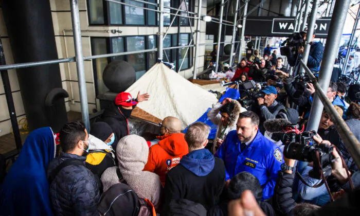 Illegal immigrants speak with NYC Homeless Outreach members as they camp out in front of the Watson Hotel after being evicted in New York City on Jan. 30, 2023. (Michael M. Santiago/Getty Images)
