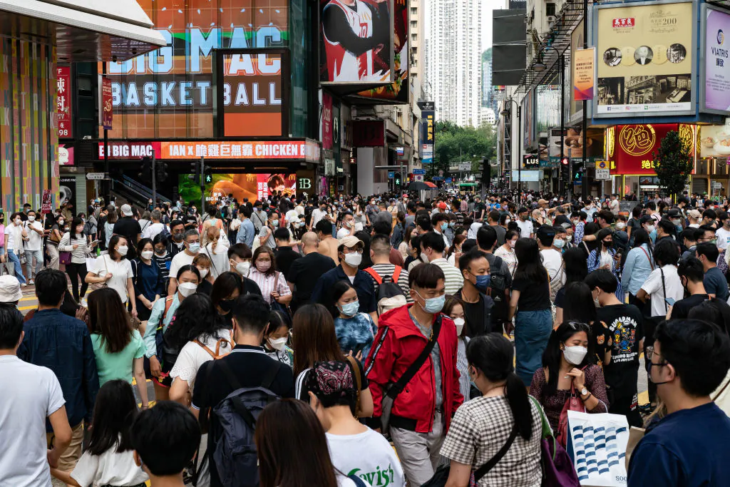 Residents cross an intersection at a shopping district in Hong Kong, on Oct. 30, 2022. (Anthony Kwan/Getty Images)