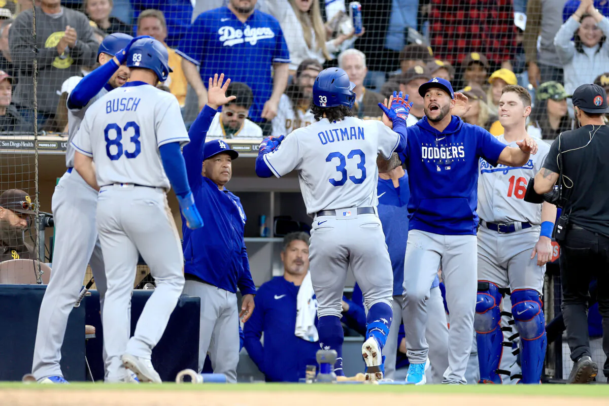 Manager Dave Roberts, Will Smith (16), and Michael Busch (83),  congratulate James Outman (33) of the Los Angeles Dodgers after his two run home-run during the 10th inning of a game against the San Diego Padres in San Diego on May 7, 2023. (Sean M. Haffey/Getty Images)