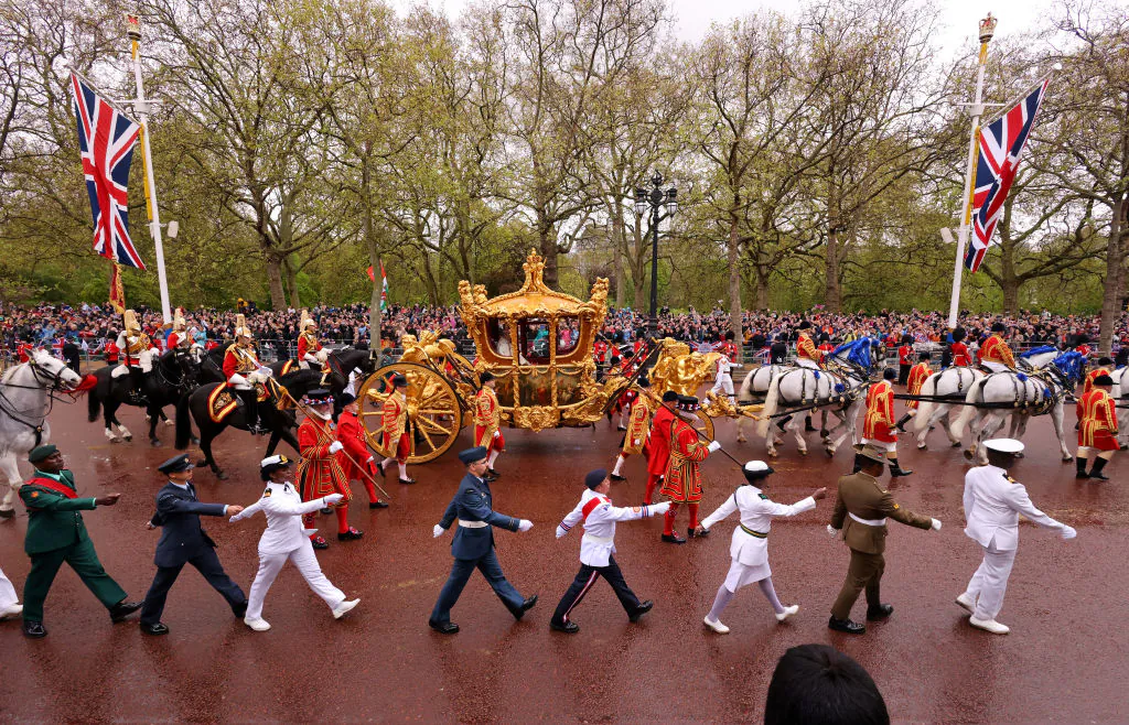 King Charles III and Queen Camilla travelling in the Gold State Coach, goes down The Mall during the Coronation of King Charles III and Queen Camilla in London, on May 6, 2023. (Richard Heathcote/Getty Images)