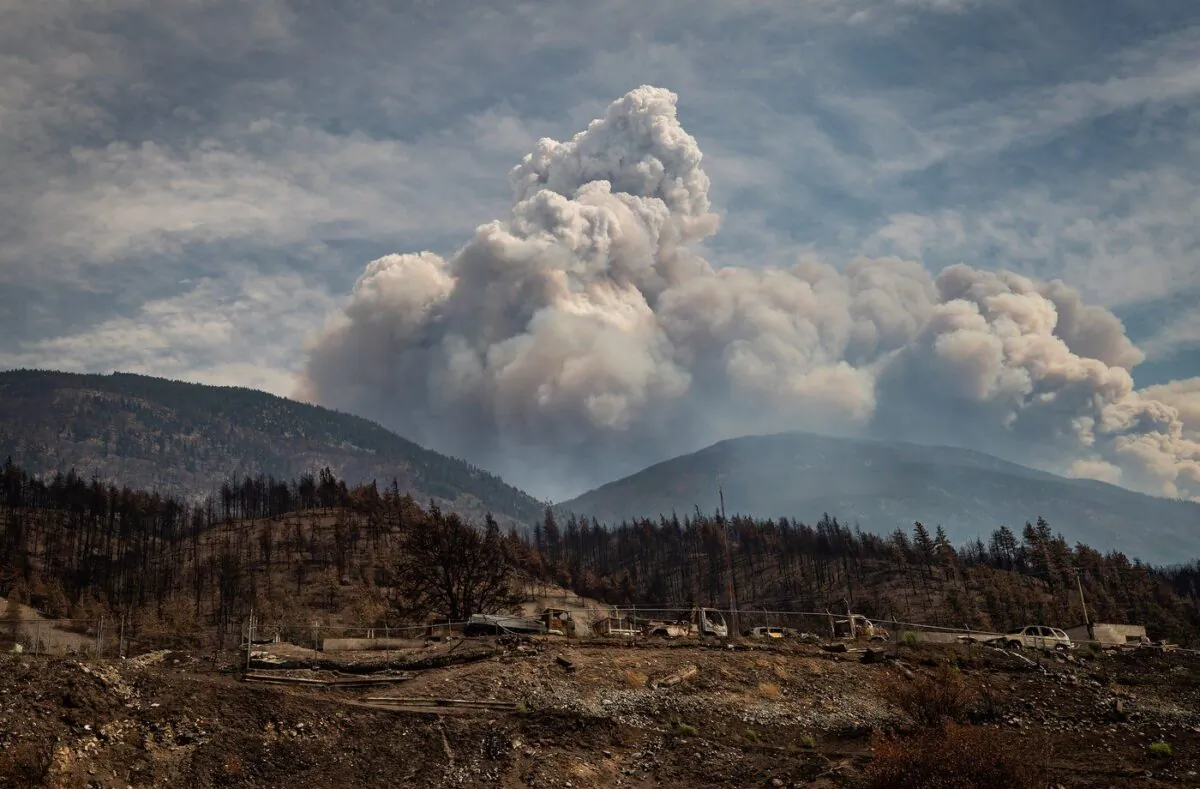 A pyrocumulus cloud, also known as a fire cloud, rises in the mountains above Lytton, B.C., on Aug.15, 2021. (The Canadian Press/Darryl Dyck)
