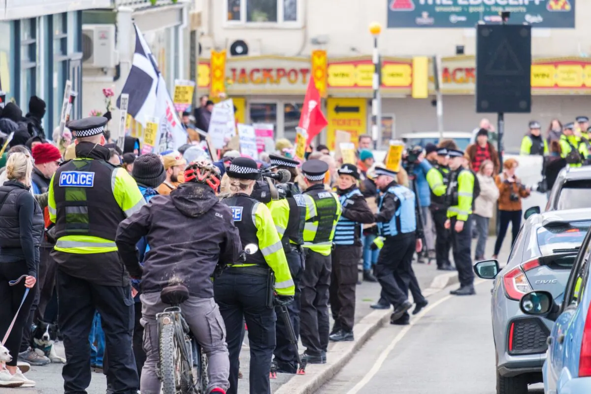 Police officers monitor a protest against illegal immigrants, organised by Patriotic Alternative, outside the Beresford Hotel in Newquay, Cornwall, England, on Feb. 25, 2023. (PA)