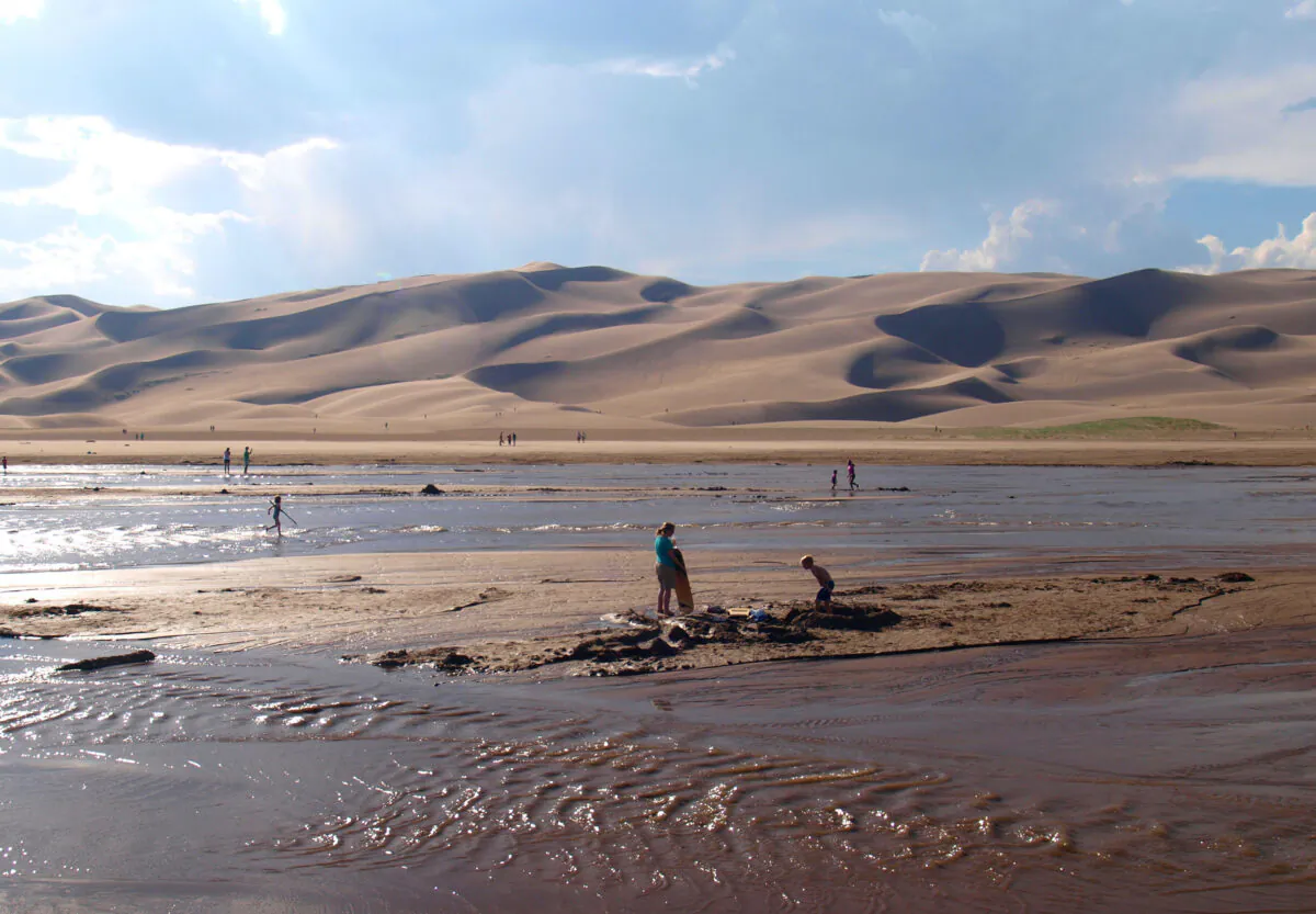 Tourists enjoy the water at Great Sand Dunes National Park, just north of Alamosa, Colorado. (Dreamstime/TNS)
