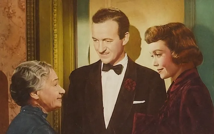 A cropped lobby card for the 1949 film "A Kiss in the Dark." (MovieStillsDB)