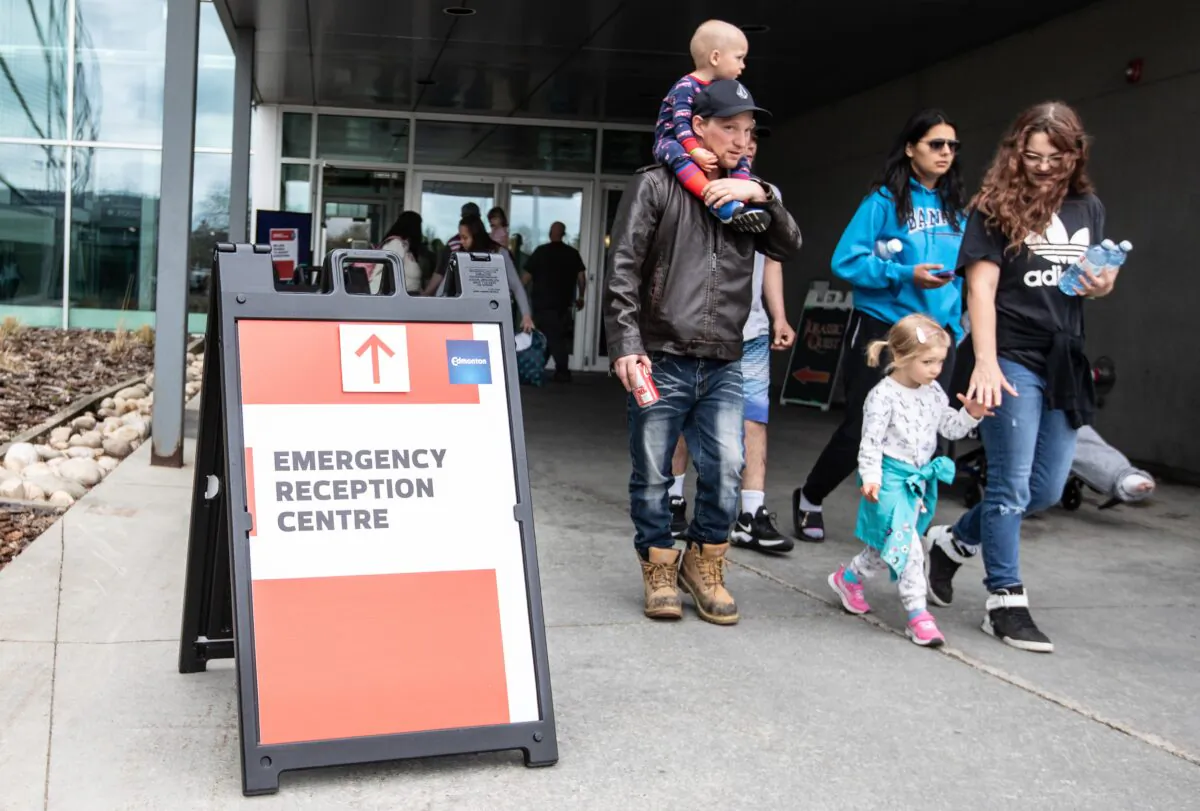 Alberta wildfire evacuees get supplies and get checked in at the evacuation centre in Edmonton, May 7, 2023. (Jason Franson/The Canadian Press)