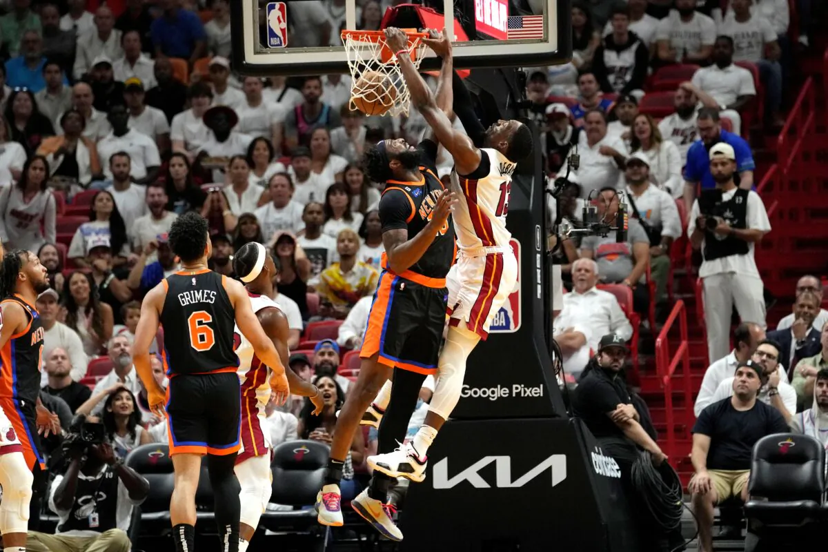 Miami Heat center Bam Adebayo, center right, dunks as New York Knicks center Mitchell Robinson, center left, defends during the first half of Game 4 of the NBA basketball Eastern Conference playoff semifinal in Miami on May 8, 2023. (Lynne Sladky/AP Photo)